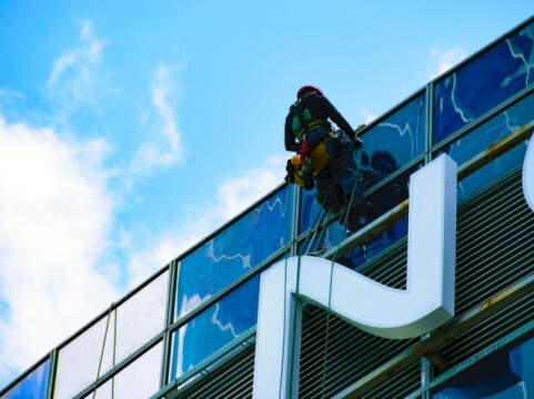 Worker fixing signage